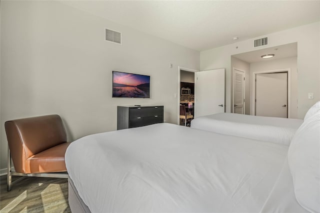 bedroom with a closet and hardwood / wood-style flooring