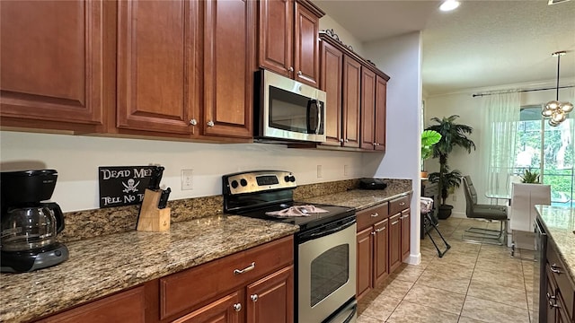 kitchen with hanging light fixtures, a notable chandelier, light tile patterned floors, stone counters, and appliances with stainless steel finishes