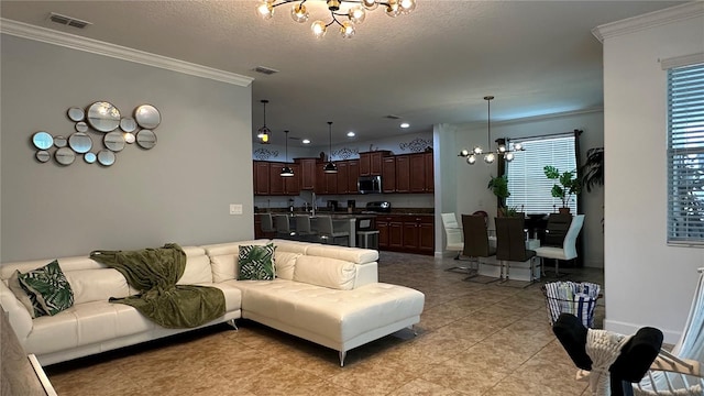 living room with a chandelier, light tile patterned flooring, crown molding, and a textured ceiling