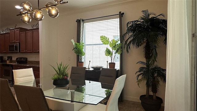 tiled dining area featuring crown molding and a notable chandelier