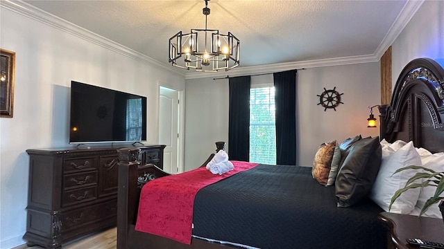 bedroom featuring ornamental molding, a textured ceiling, and a chandelier