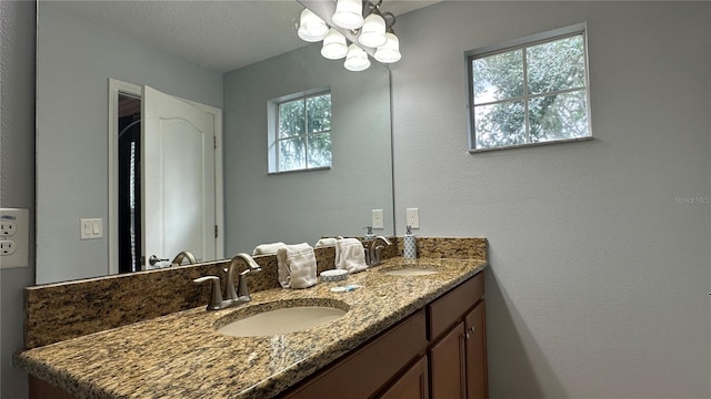 bathroom featuring vanity, a textured ceiling, and plenty of natural light