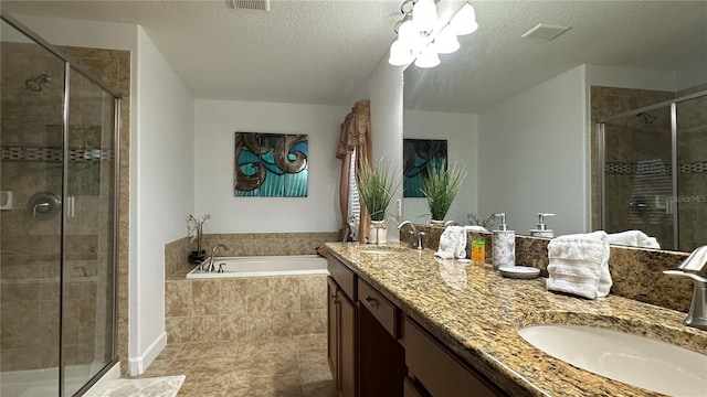 bathroom featuring vanity, a textured ceiling, and plus walk in shower