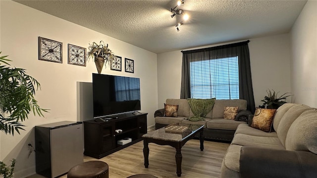 living room with light hardwood / wood-style flooring and a textured ceiling