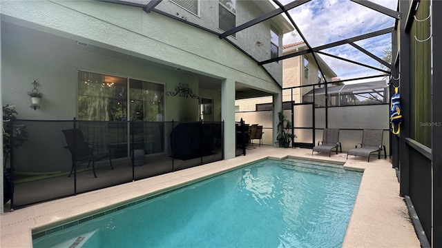 view of pool with a patio and a lanai