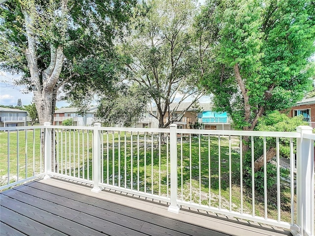 wooden deck featuring a yard