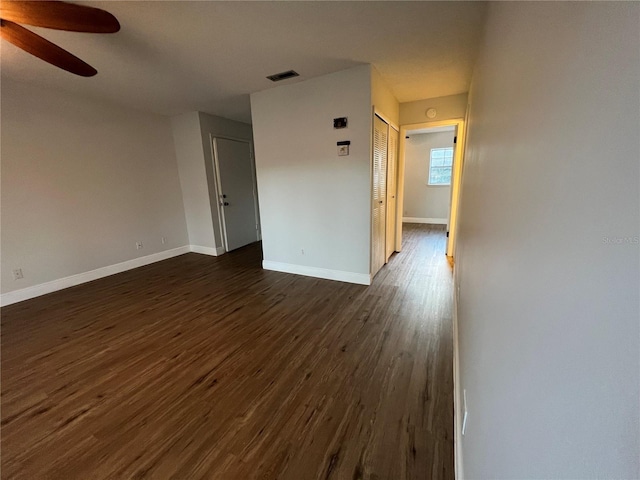 empty room featuring ceiling fan and dark hardwood / wood-style floors