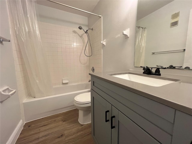 full bathroom with wood finished floors, toilet, vanity, and shower / tub combo with curtain