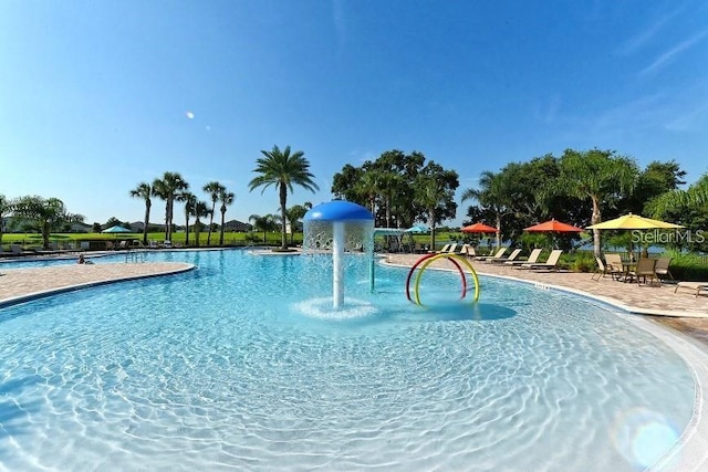 view of pool with pool water feature and a patio