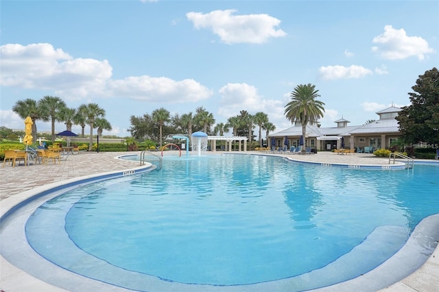 view of swimming pool with a patio area and pool water feature