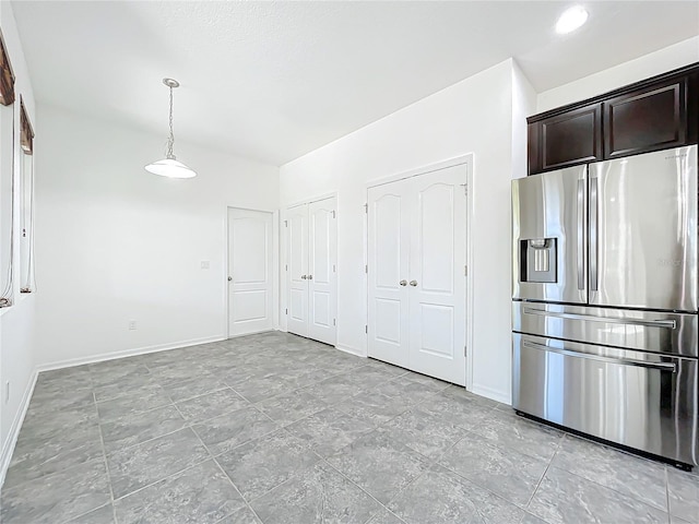 kitchen with dark brown cabinetry, stainless steel refrigerator with ice dispenser, and hanging light fixtures