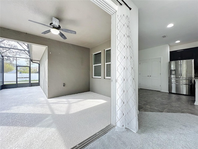 view of patio featuring a lanai and ceiling fan