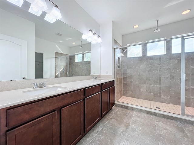 bathroom featuring vanity and a shower with shower door