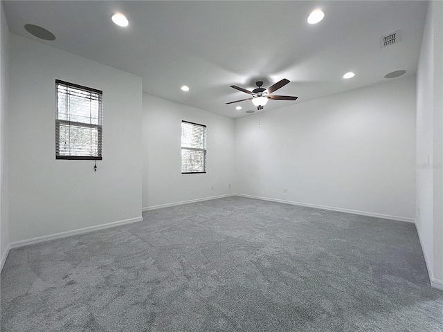 spare room with carpet and ceiling fan