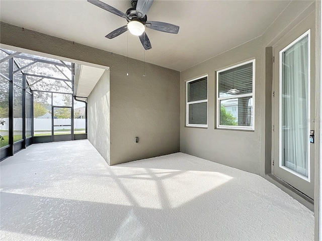 view of patio / terrace with ceiling fan and a lanai