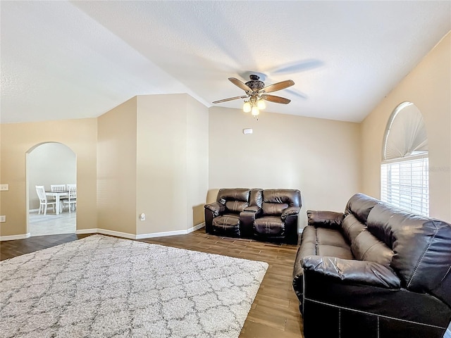 living room featuring lofted ceiling, hardwood / wood-style floors, a textured ceiling, and ceiling fan