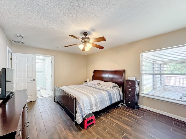 bedroom featuring connected bathroom, ceiling fan, a textured ceiling, and dark hardwood / wood-style flooring