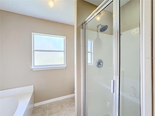 bathroom featuring tile patterned floors, a textured ceiling, and shower with separate bathtub