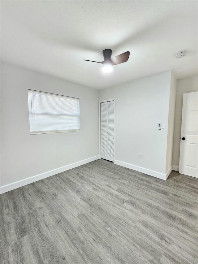 empty room featuring hardwood / wood-style floors and ceiling fan