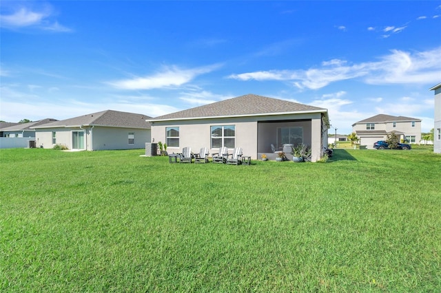 rear view of property featuring a yard