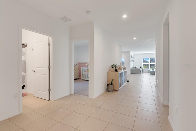 hall featuring light tile patterned floors