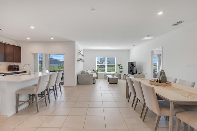 tiled dining room featuring sink