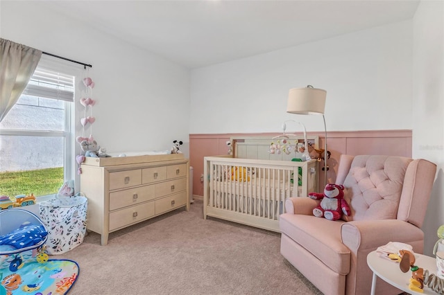 bedroom with light carpet and a crib