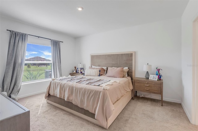 bedroom featuring light colored carpet