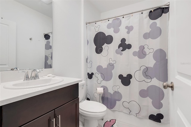 bathroom with vanity, toilet, and tile patterned flooring