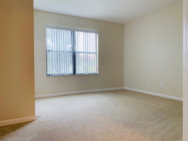 spare room with light colored carpet