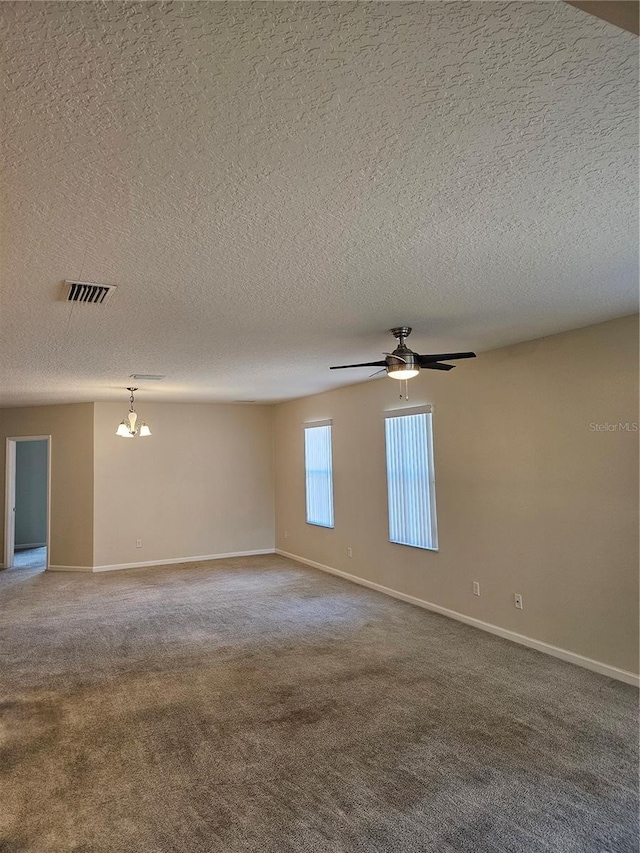 unfurnished room featuring carpet and ceiling fan with notable chandelier