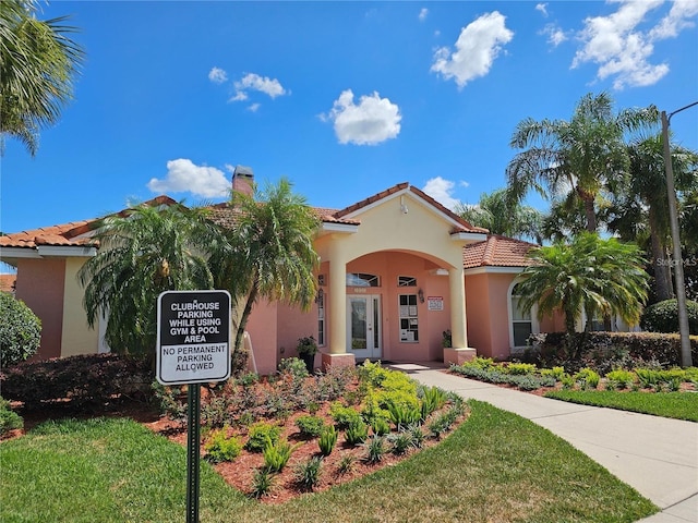 mediterranean / spanish-style house featuring a front yard