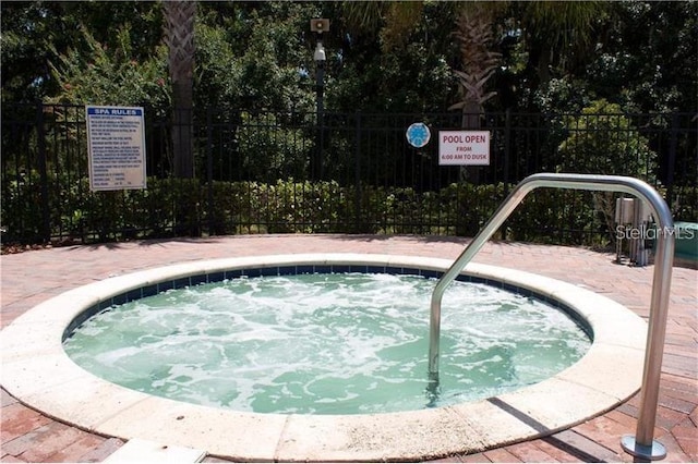 view of pool with a hot tub