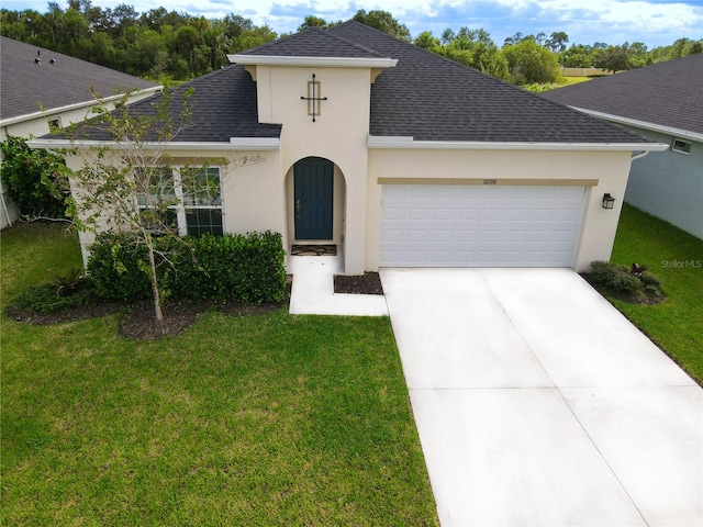 view of front of property with a garage and a front lawn