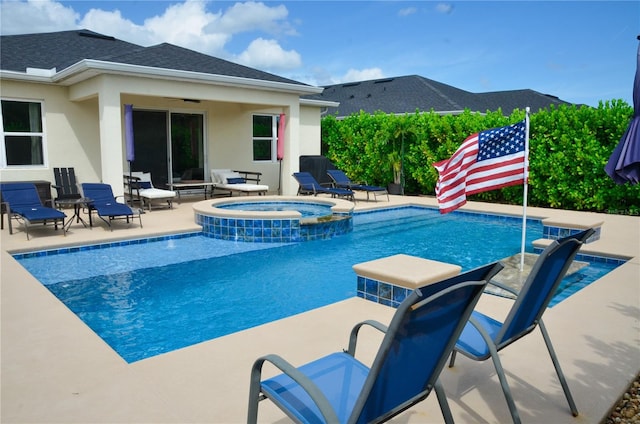 view of swimming pool with an in ground hot tub and a patio area