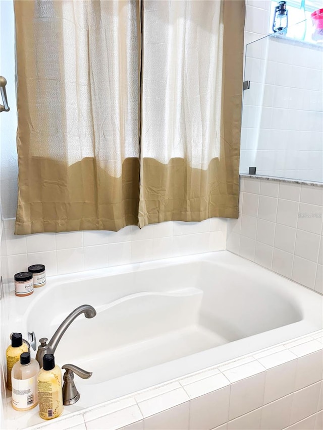 bathroom featuring tiled bath