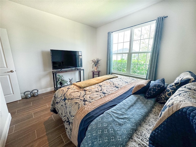 bedroom with dark wood-type flooring