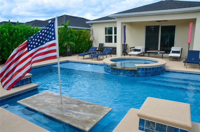 view of swimming pool with an in ground hot tub and a patio area