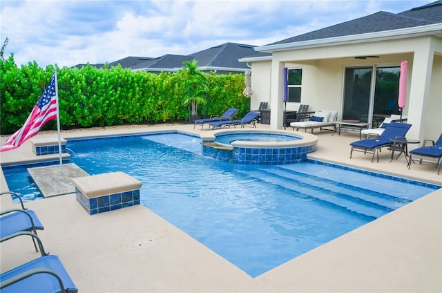 view of swimming pool featuring an in ground hot tub, pool water feature, and a patio area