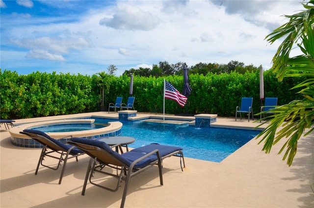 view of swimming pool featuring a patio, pool water feature, and an in ground hot tub