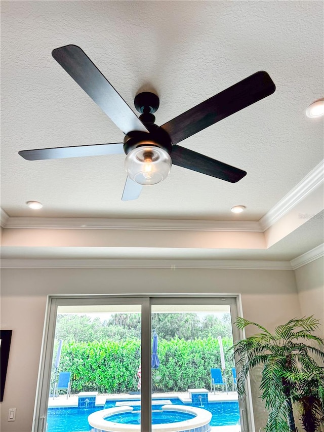 room details featuring crown molding, a textured ceiling, a raised ceiling, and ceiling fan