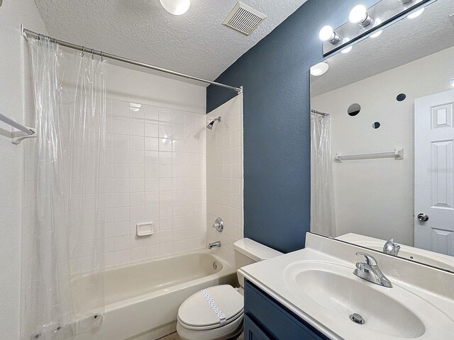 full bathroom featuring toilet, a textured ceiling, shower / bath combination with curtain, and vanity