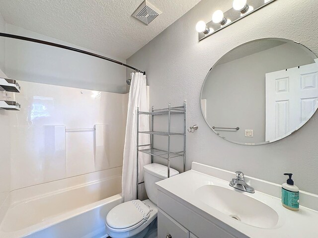 full bathroom featuring toilet, a textured ceiling, shower / bathtub combination with curtain, and vanity