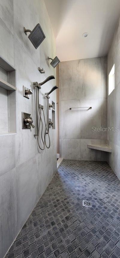 bathroom with a tile shower