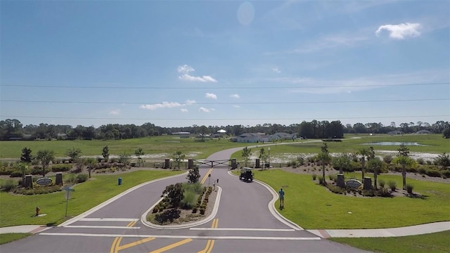 view of home's community with a yard and a water view