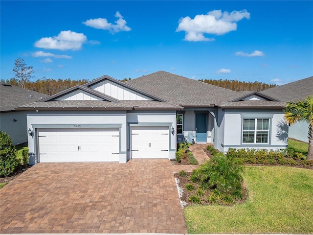 ranch-style home with a garage, a front lawn, decorative driveway, and stucco siding