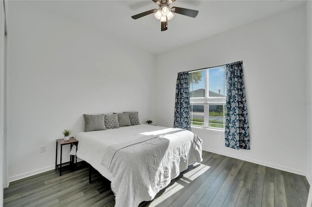 bedroom featuring wood finished floors, a ceiling fan, and baseboards