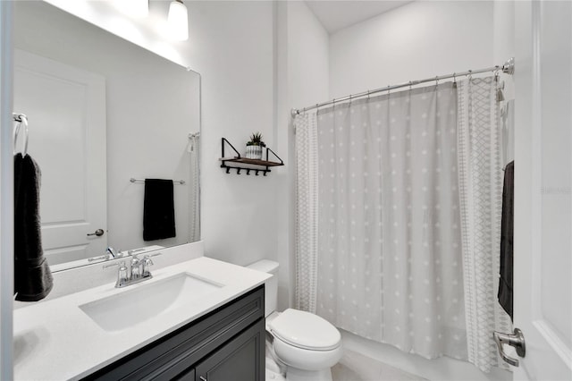 full bathroom featuring tile patterned floors, shower / bath combo with shower curtain, vanity, and toilet