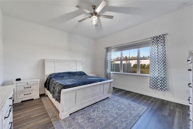 bedroom featuring dark wood-style floors, ceiling fan, and baseboards