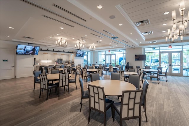 dining area with a tray ceiling, french doors, visible vents, and recessed lighting